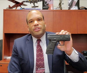 A still picture from the Iowa Permit to Carry Weapons training video. Attorney Eric D. Puryear holding a handgun